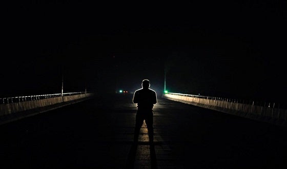 Man standing in dark street